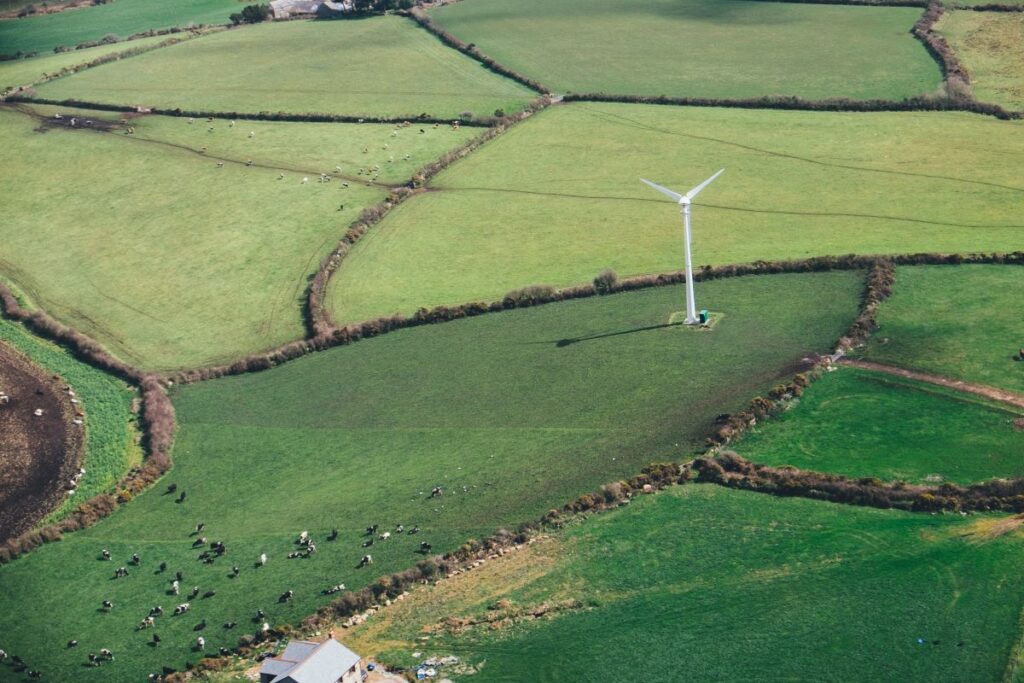 A wind turbine in a field used to save energy