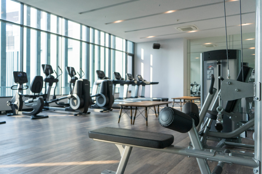 Treadmills, exercise bikes and a weightlifting machine in a gym