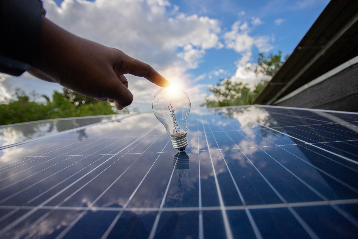 A lightbulb balanced on a solar panel